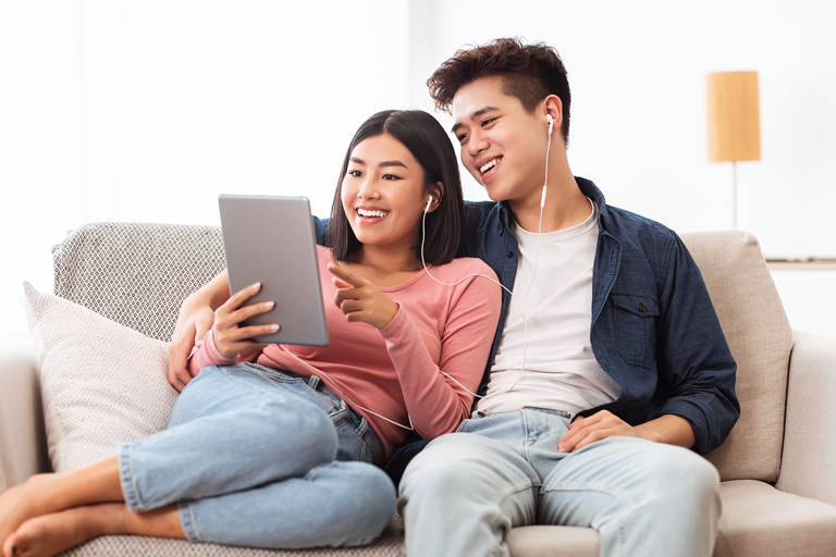 cheerful-asian-couple-using-digital-tablet-browsin-2021-08-29-10-49-39-utc.jpg